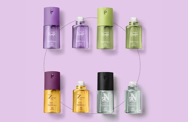 Cuatro desodorantes corporales Natura (Humor, Luna, SRN) en colores morado, verde, dorado y gris, junto a sus respectivos envases de recarga, dispuestos en un patrón circular sobre un fondo lila.